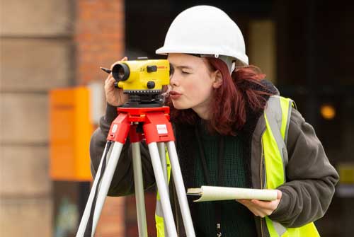 Female student uses construction equipment